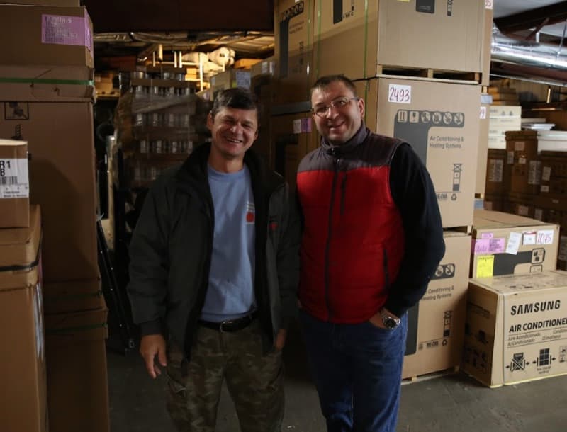 Steady Flame Fireplaces team members smiling in warehouse
